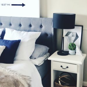 Bedside table and styled bed