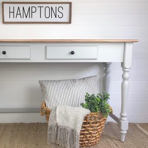 Side table with Hamptons sign above
